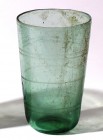 A TRANSLUCENT GLASS BEAKER Roman Period, 1st-2nd century CE. 9.9 cm high. With incised circular decorations. In very good condition.