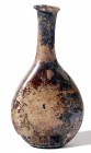 A LIGHT-OBERGINE GLASS FLASK 3rd-4th century CE. With nice patina and in very good condition. 13.3 cm high. Ex Yoav Sasson collection, Jerusalem.