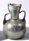 A GLASS JAR WITH 2 HANDLES Byzantine Period, 4th-5th century CE. 11.4 cm high. With very nice silver patina and in very good condition. Ex Shlomo Mous...
