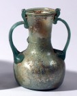 A GLASS JAR WITH 2 HANDLES Byzantine Period, 4th-5th century CE. 10.8 cm high. In very good condition. Ex Yoav Sasson collection, Jerusalem.