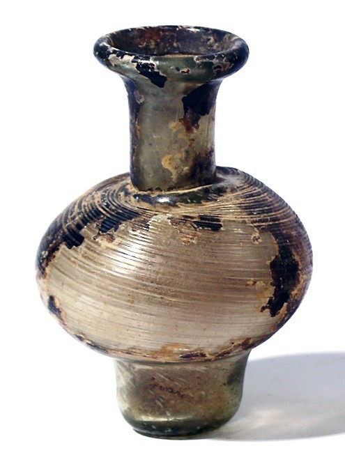 A TRANSLUCENT GLASS SPRINKLER Byzantine Period, 4th-5th century CE. 12.1 cm high...