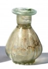 A TRANSLUCENT GLASS SPRINKLER Byzantine Period, 4th-6th century CE. 8.0 cm high. In the shape of a poppy. Minor base damage but in very good condition...