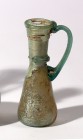 A LIGHT GREEN GLASS JUGLET Byzantine Period, 5th-6th century CE. 10.7 cm high. With nice internal silver patina and in very good condition. Ex Yoav Sa...
