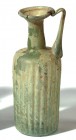 A LIGHT GREEN GLASS RIBBED JUGLET Byzantine Period, 5th-6th century CE. 13.9 cm high. With nice patina and in very good condition. Ex Yoav Sasson coll...