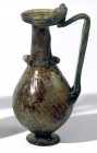 A GREEN GLASS JUG Byzantine Period, 5th century CE. 16.2 cm high. Repaired but in fair condition. Ex Abraham Rosen collection, New York.