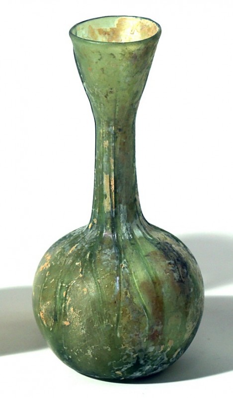 A GREEN GLASS BOTTLE Byzantine Period, 4th-6th century CE. 14.5 cm high. In very...