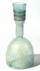 A LARGE TRANSLUCENT GLASS BOTTLE 4th-5th century CE. 28 cm high. The neck with dark green trail decoration. In perfect condition.