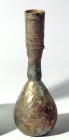 A TRANSLUCENT GLASS BOTTLE WITH DIAGONAL RIBBED BODY Byzantine Period, 5th-6th century CE. 22 cm high. With some nice patina and in very good conditio...