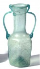 A TRANSLUCENT GREEN GLASS HEXAGONAL FLASK WITH TWO HANDLES 5th-6th century CE. 16.3 cm high. Blown in a mold, two sides are decorated with diamond-sha...