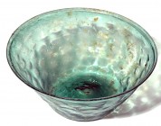 A GREEN GLASS HONEYCOMB BOWL Early Islamic Period, 8th century CE. 19.5 cm in diameter. With a small old crack at the base but in good condition. Ex A...
