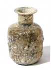 A CYLINDRICAL GLASS JAR Islamic Period, 7th-9th century CE. 9.2 cm high. Blown in a mold and decorated with geometric patterns. In very good condition...