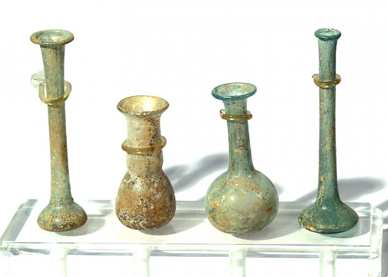 A LOT OF 4 PERFUME GLASS BOTTLES Roman Period, 1st-4th century CE. 11-7 cm high....