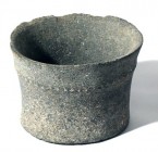 A BASALT BOWL WITH ROPE DECORATION Chalcolithic Period, 4th millennium BCE. 18.8 cm in diameter, 14.3 cm high. With minor rim chips but in very good c...