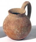 A TERRACOTTA MUG WITH HIGH HANDLE Early Bronze Age, 3100 – 2900 BCE. 11.8 cm high. In very good condition. Ex David Bergman collection, Haifa.