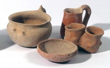 A LOT OF 4 TERRACOTTA VESSELS Early Bronze Age, ca. 3000 BCE. A bowl with a handle, 9.3 cm in diam., a mini mug with high handle, 6.9 cm high, a mini ...