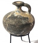 A TEL EL-YAHUDIYEH BLACK TERRACOTTA JUGLET Middle Bronze Age, 1730 – 1550 BCE. 9.3 cm high. With punctured decorated. In very good condition. Ex David...