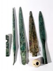 5 CANAANITE BRONZE WEAPONS Middle Bronze Age, 1830 – 1550 BCE. Including two dagger blades, a spear-head and terminal, a piercing axe and a stone pomm...