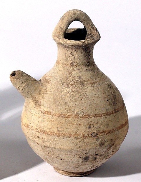 A CANAANITE TERRACOTTA JUGLET Late Bronze Age, 1550 – 1200 BCE. 14.9 cm high. Sp...