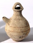 A CANAANITE TERRACOTTA JUGLET Late Bronze Age, 1550 – 1200 BCE. 14.9 cm high. Spouted and with a basket handle. With some brown linear decorations. In...