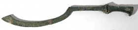 A CAST BRONZE SICKLE-BLADE SWORD Late Bronze Age, 16th-12th century BCE. 59 cm long. Broken in the middle in two pieces but in very good condition and...