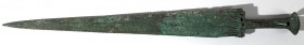 A LURISTAN BRONZE SWORD Iron Age, 12th-8th century BCE. 56.7 cm long. The ribbed blade is cast together with the handle. Minor chip at the base of the...
