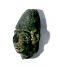 A CANAANITE BRONZE STATUETTE HEAD Late Bronze Age, ca. 14th century BCE. 3.4 cm high. With nice black patina. Good condition. Ex Shlomo Moussaieff col...