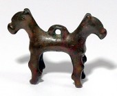 A BRONZE SIAMESE HORSE Iron Age II, ca 8th century BCE. 8.3x6.4 cm. With very nice brown patina and in very good condition. Ex Yoav Sasson collection,...