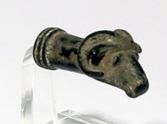 A BRONZE RAM HEAD TERMINAL Iron Age, 8th-7th century BCE. 4.7 cm. With very nice glossy black patina. In very good condition. Ex Shlomo Moussaieff col...