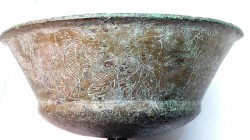 A PHOENICIAN BRONZE BOWL Iron Age II, 8th-7th century BCE. 15.5 cm in diameter. Decorated with an ibex flanked by two griffins and a chain of 8 lotus ...