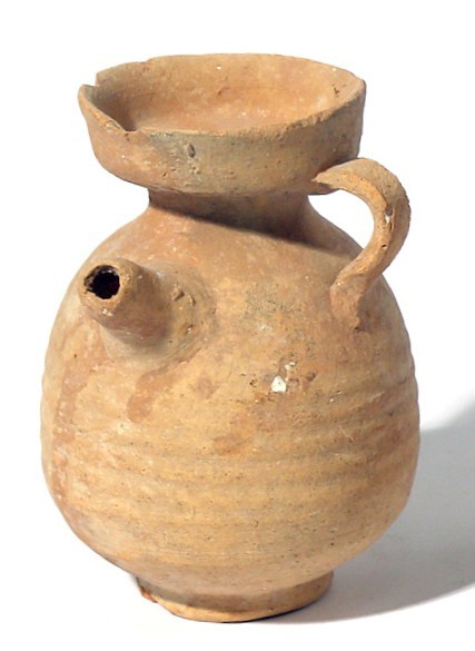 A TERRACOTTA JUGLET WITH SPOUT Roman Period, ca. 1st century CE. 10.2 cm high. I...