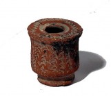 A REDDISH CERAMIC INKWELL Roman Period, 1st-4th century CE. With incised zigzag decorations on the rim and around the body. In very good condition. 4....