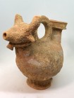 A ZOOMORPHIC TERRACOTTA ASKOS Byzantine Period, 4th-6th century CE. 15 cm long, 12.5 cm high. The tip of the horns are missing but in good condition. ...