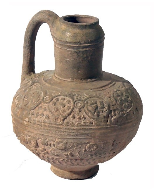 AN ISLAMIC TERRACOTTA JUG 13th century CE. 15.7 cm high. Depicting floral and ge...