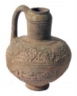 AN ISLAMIC TERRACOTTA JUG 13th century CE. 15.7 cm high. Depicting floral and geometric motifs. In very good condition. Ex Aka Mizrahi collection, Tib...