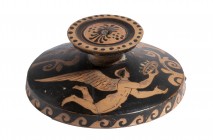 Apulian or Sicilian Red-Figure Lid; 4th century BC; diam cm 14; Very fine Lekanis Lid decorated with two winged erotes, one of them holds a phiale; tw...