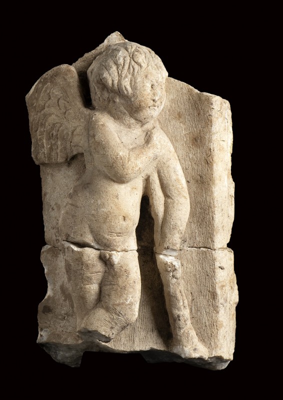 Roman Marble Relief with an Erote holding Torch downward, 2nd - 3rd century AD; ...