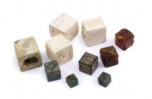 Amazing Collection of Gaming Dices, 1st – 3rd century AD; height max cm 2,4; Composed by two dices in amber, four in bones, three in bronze and the sm...