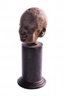 A male head in the Grotesque style
Egypt, 2nd - 1st century BC
; alt. cm 7; A small head set on a wooden base; the masculine face is distinguished b...