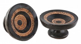 A pair of small Apulian plates
3rd century BC; alt. cm 8 e 8,5; A pair of small plates decorated with black glaze and on high tapering feet, with sha...