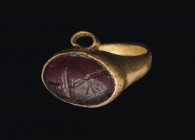 Small Roman gold finger ring with garnet Intaglio
1st – 2nd century AD; diam. int. mm 11; gr 2,29; A small gold finger ring with garnet Intaglio depi...