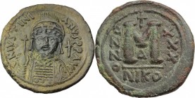 Justinian I (527-565). AE Follis. Nicomedia mint, 1st officina. Dated RY 30 (556/7 AD). D/ Helmeted and cuirassed bust facing, holding globus cruciger...