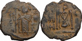 Arab-Byzantine, Umayyad Caliphate. AE Fals, Hims (Emesa) mint, c. 680-693. D/ Standing emperor in military dress and holding long cross and globus cru...