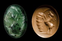 A roman green chromium chalcedony intaglio. Goat.
2nd century A.D.
6 x 8 x 2 mm

The animal is facing right, uprising his upper legs to reach a pa...