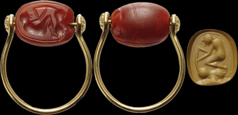 An etruscan intaglio on carnelian scarab set on a modern gold ring. Male figure ...