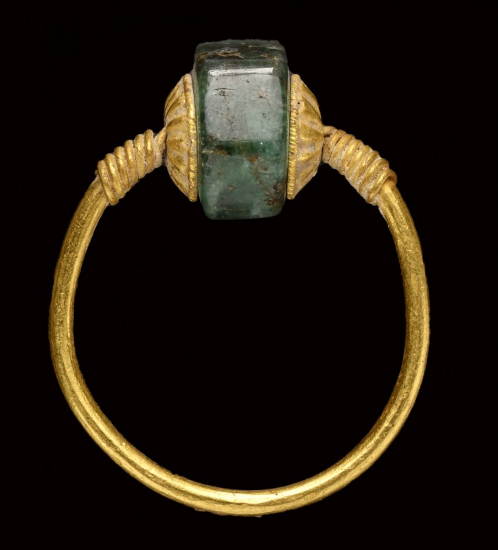 A late hellenistic gold ring with a hexagonal emerald rotating bezel.
2nd - 1st...