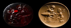 A postclassical garnet intaglio. Two winged erotes with amphora.
19th century
11 x 14 x 4 mm

The winged figures are facing each other. One is hol...