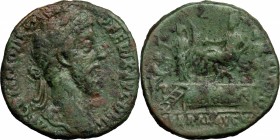 Commodus (177-192). AE Sestertius, 186 AD. D/ M COMMODVS ANT P FELIX AVG BRIT. Laureate head right. R/ Commodus seated left on platform, attended by o...