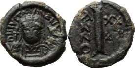 Justinian I (527-565). AE Decanummium; Ravenna mint. D/ DN IVSTINIANVS PP. Helmeted and cuirassed bust facing, holding globus cruciger and shield. R/ ...