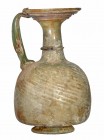 ROMA. Imperio Romano. Vidrio. Jarrita con irisaciones y pátina opaca. Altura: 13,2 cm. S. II d.C.