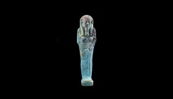 An Egyptian faience ushabti. 6th-5th century BC. 13.3cm high. From an esteemed American collection; formerly acquired in the 1970-1980s